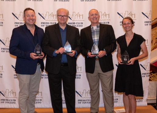 Shane Potgieter, Brad Cresswell, Chris Peiffer and Mary Claire Murphy pose with their Touchstone Award trophies