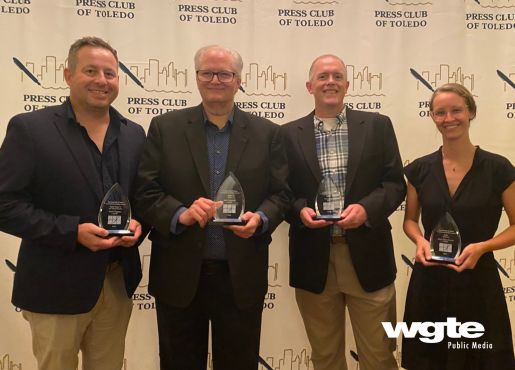 Shane Potgieter, Brad Cresswell, Chris Peiffer and Mary Claire Murphy pose with their Touchstone Award trophies